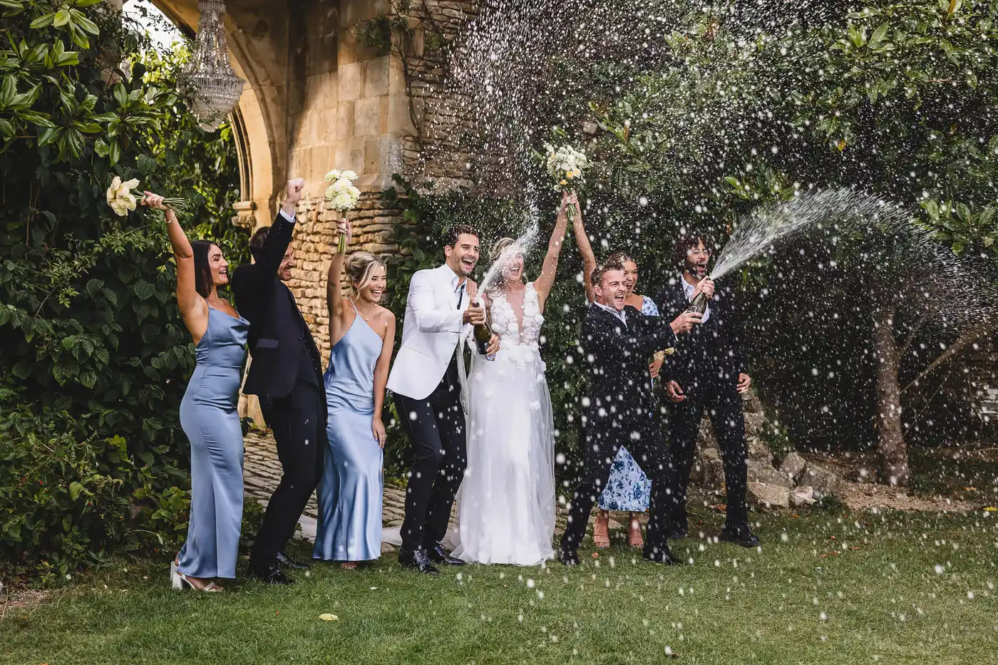 Bride & Groom in a confetti tunnel outside church in Dorset